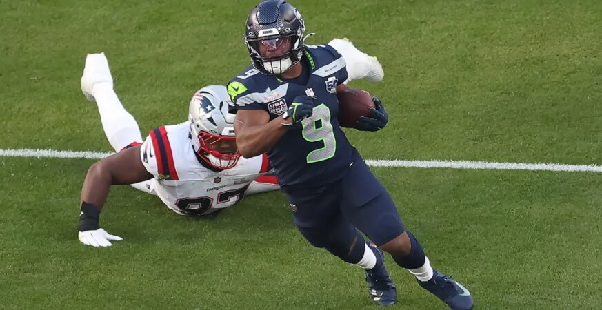 Kenneth Walker III #9 of the Seattle Seahawks breaks a tackle against Milton Williams #97 of the New England Patriots during the second quarter in Super Bowl LX at Levi's Stadium on February 08, 2026 in Santa Clara, California.
