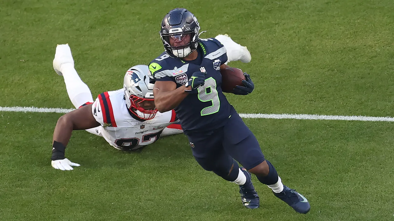 Kenneth Walker III #9 of the Seattle Seahawks breaks a tackle against Milton Williams #97 of the New England Patriots during the second quarter in Super Bowl LX at Levi's Stadium on February 08, 2026 in Santa Clara, California.