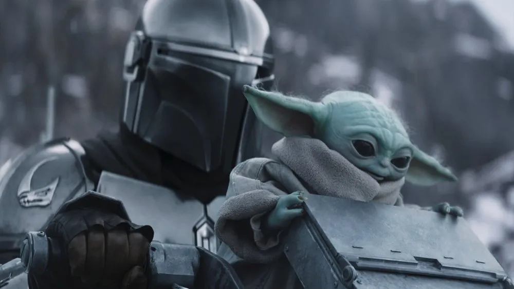 STAR WARS: THE MANDALORIAN AND GROGU, from left: Pedro Pascal as The Mandalorian / Din Djarin, Grogu, 2026. © Walt Disney Studios Motion Pictures / Courtesy Everett Collection