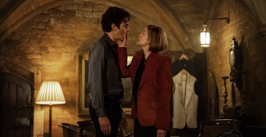 (L-R) Sacha Baron Cohen as Damien Sachs and Rosamund Pike as Alex Fox in Ladies First.