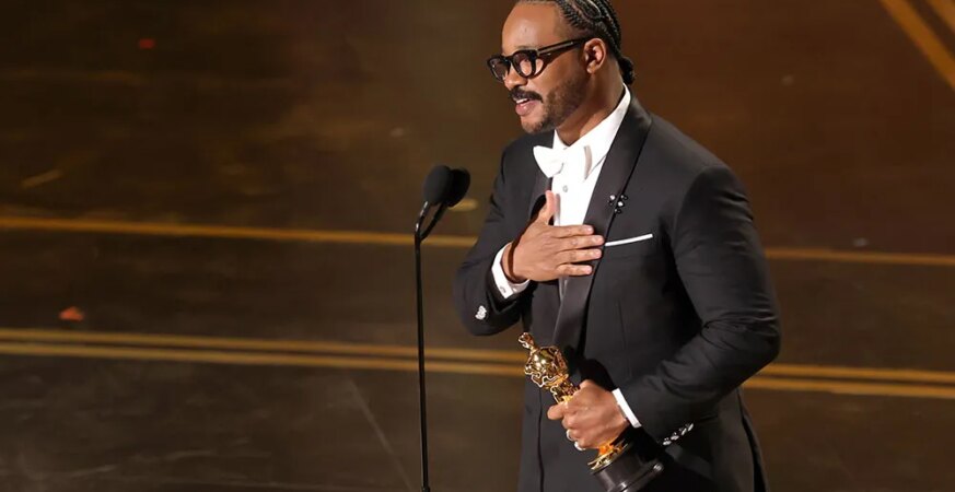Ryan Coogler accepts the Writing (Original Screenplay) award for "Sinners" onstage during the 98th Oscars at Dolby Theatre on March 15, 2026 in Hollywood, California.