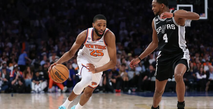 Mikal Bridges (25) of the New York Knicks drives against De'Aaron Fox of the San Antonio Spurs during game 3 of the 2026 NBA Finals.