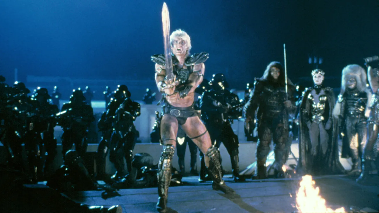 Dolph Lundgren, a former chemical engineer who gave up a Fulbright Scholarship to MIT to pursue acting, as He-Man in Masters of the Universe, which some critics compared unfavorably to Star Wars.